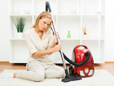 Beautiful housewife with vacuum cleaner
