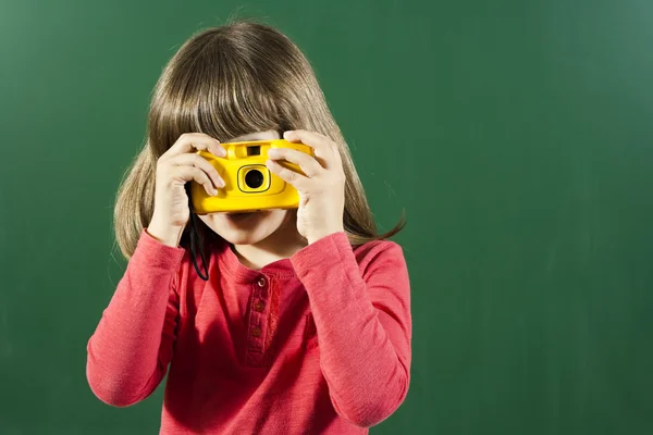 Cute little girl holding camera — Stock Photo, Image