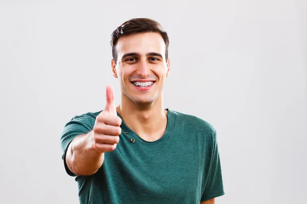 Man with braces showing thumbs up — Stock Photo, Image