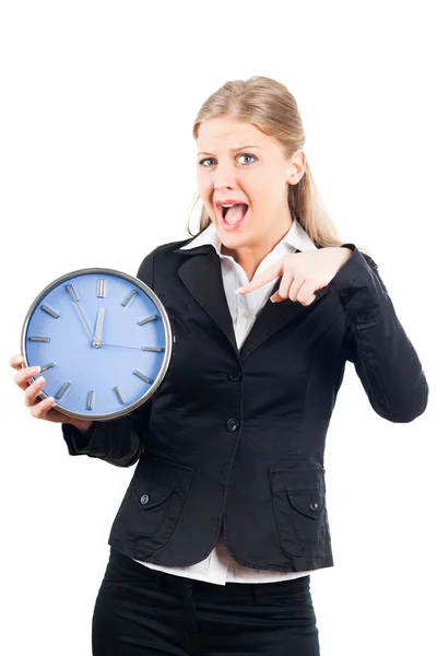 Mujer de negocios frustrada apuntando al reloj de pared — Foto de Stock