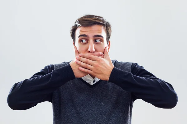 Young businessman covering mouth with hands — Stock Photo, Image