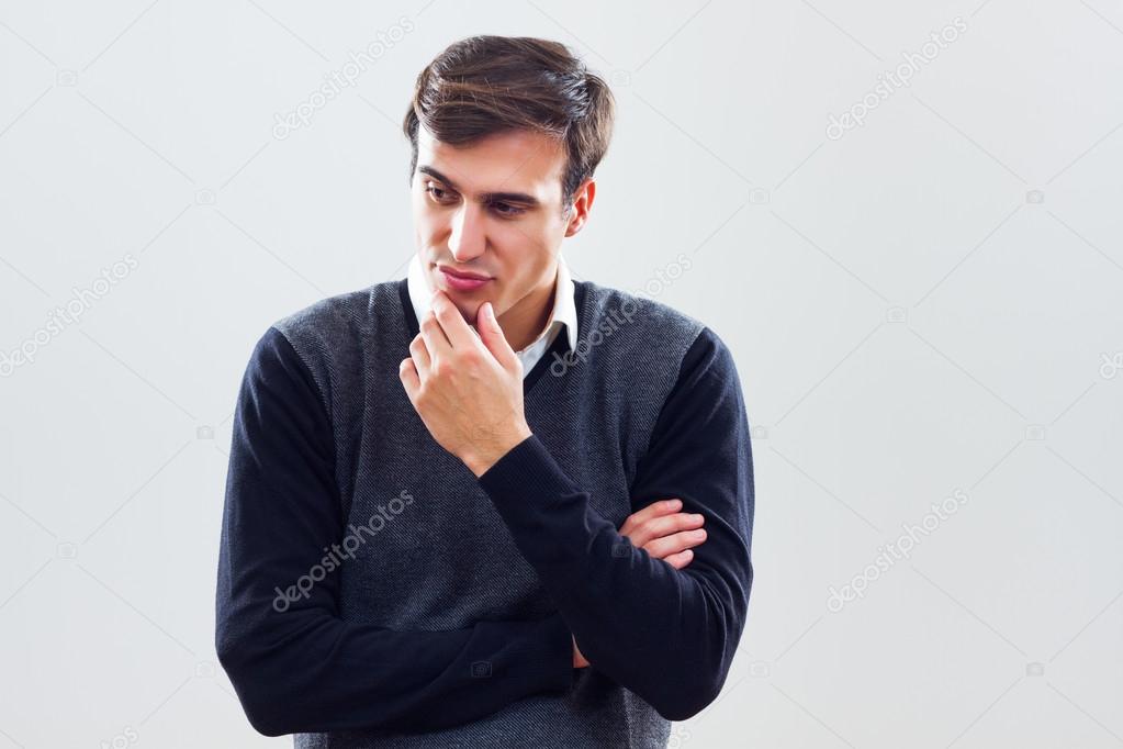 Young businessman is thinking about something