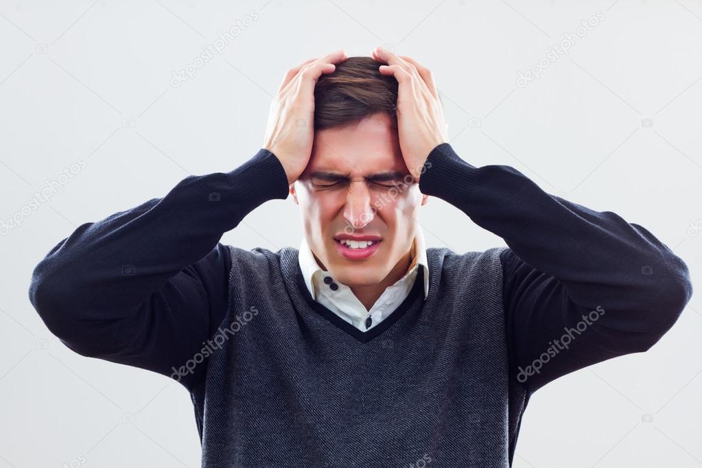 Frustrated businessman holding head