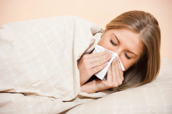 Woman blowing into tissue — Stock Photo, Image