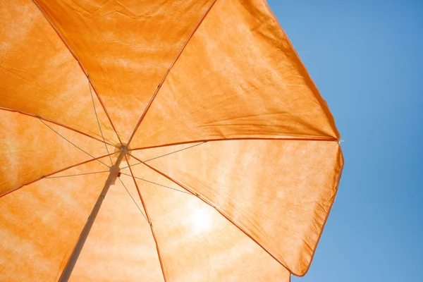 Beach umbrella on the blue sky — Stock Photo, Image