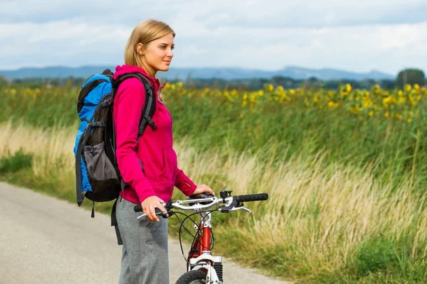 Woman with a bike on nature — Stock Photo, Image