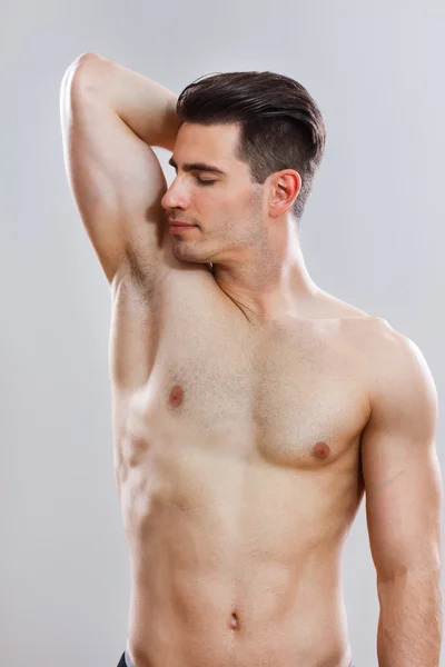 Handsome man smells under armpit — Stock Photo, Image