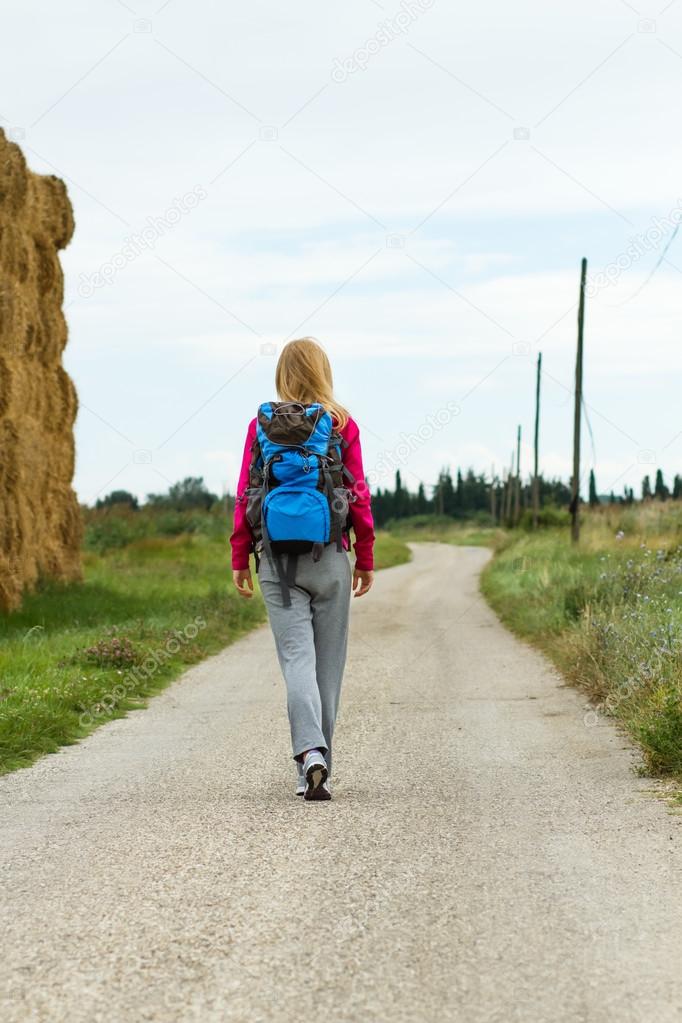 Woman walking country road