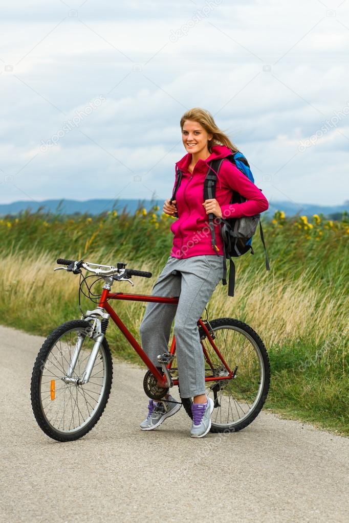 Woman with a bike on nature