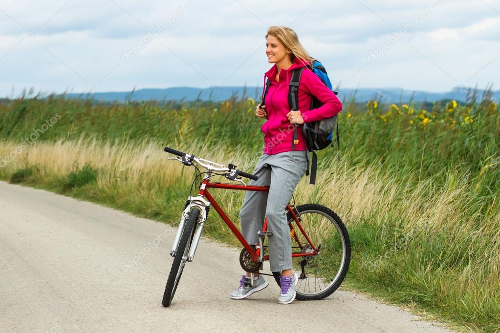 Woman with a bike on nature