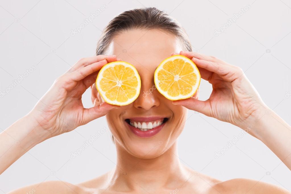 woman with slices of lemon.
