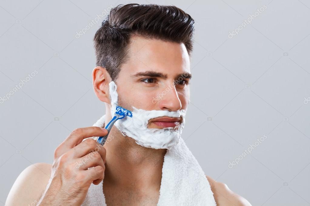 Photo of handsome man shaving his face — Stock Photo © inesbazdar 72775817