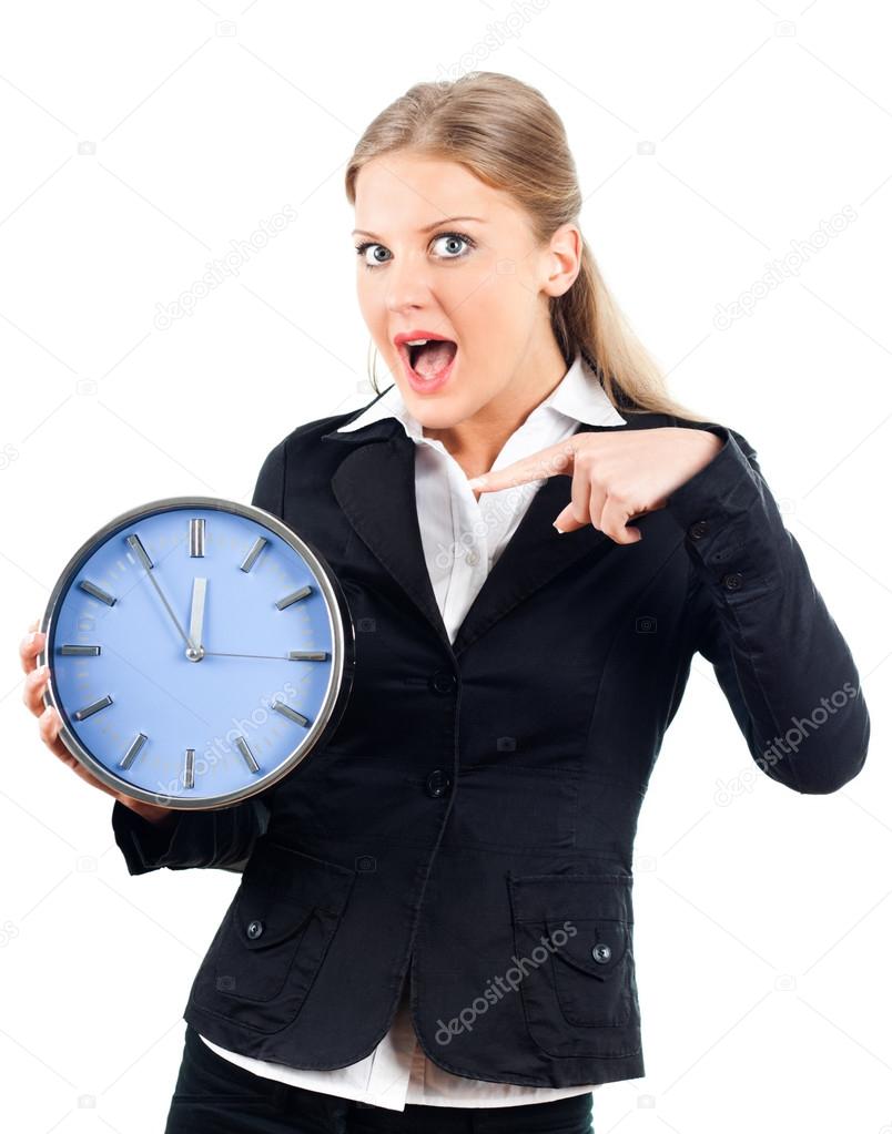 Beautiful businesswoman pointing at wall clock