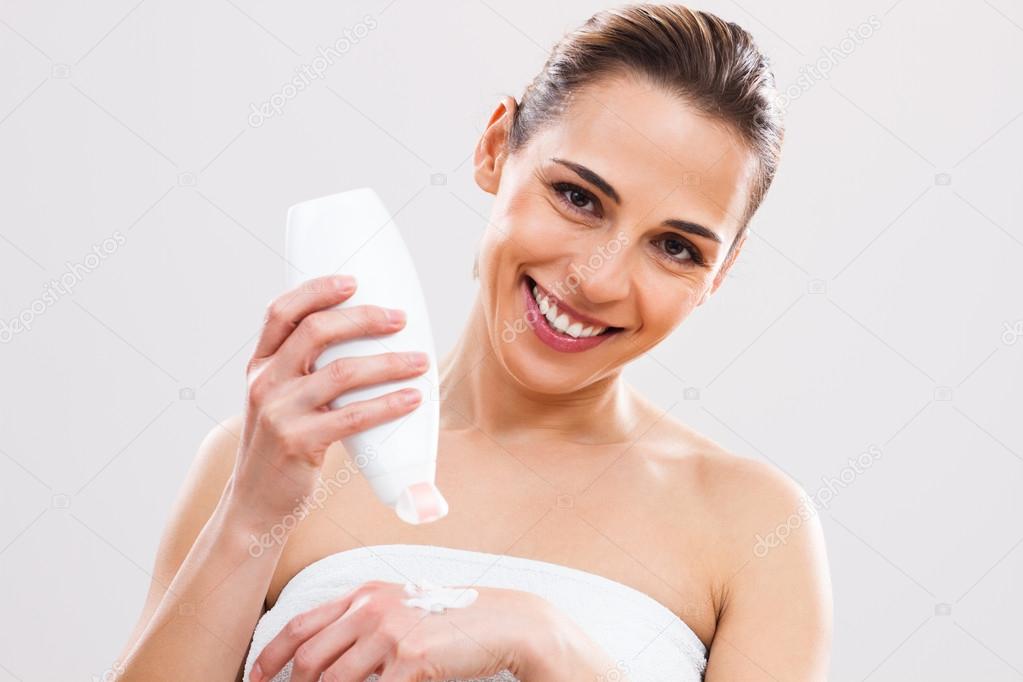 Woman applying lotion