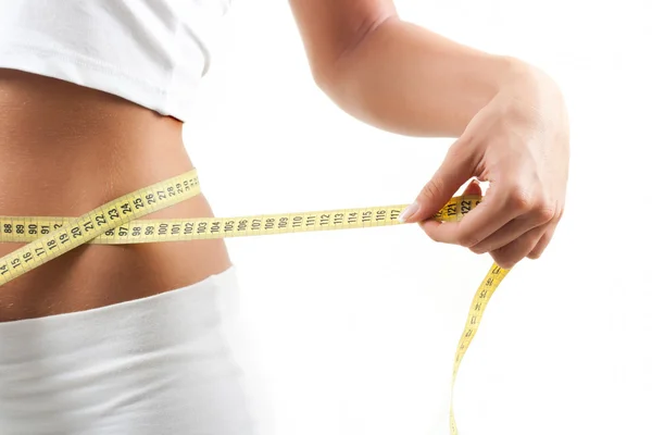 Young woman measuring belly after diet — Stock Photo, Image