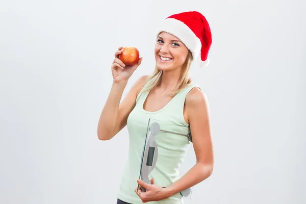 Санта-женщина с весами и яблоками — стоковое фото