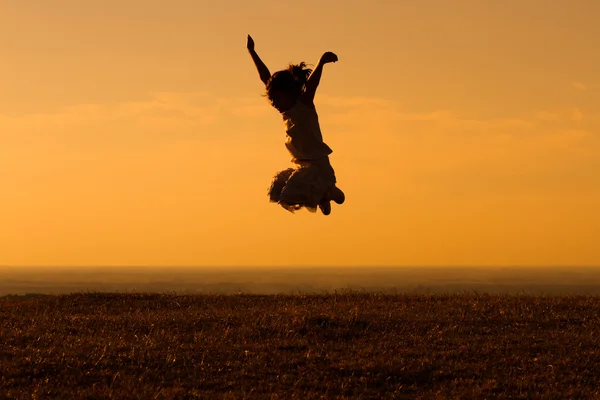 Little girl jumping in nature — Stock Photo, Image