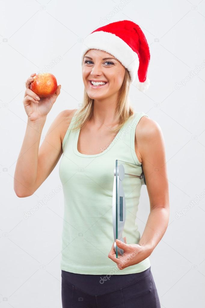 santa woman with apple and scale