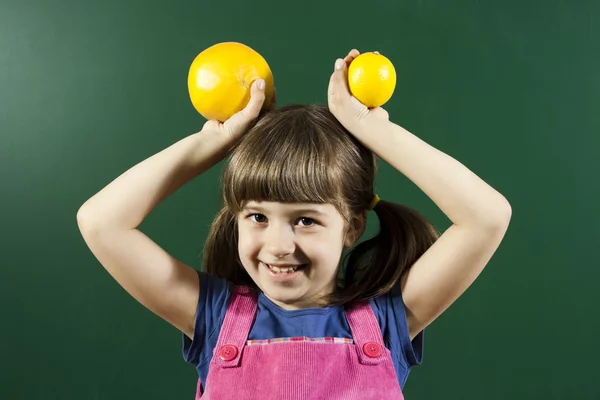Little girl with fruits — Stock Photo, Image
