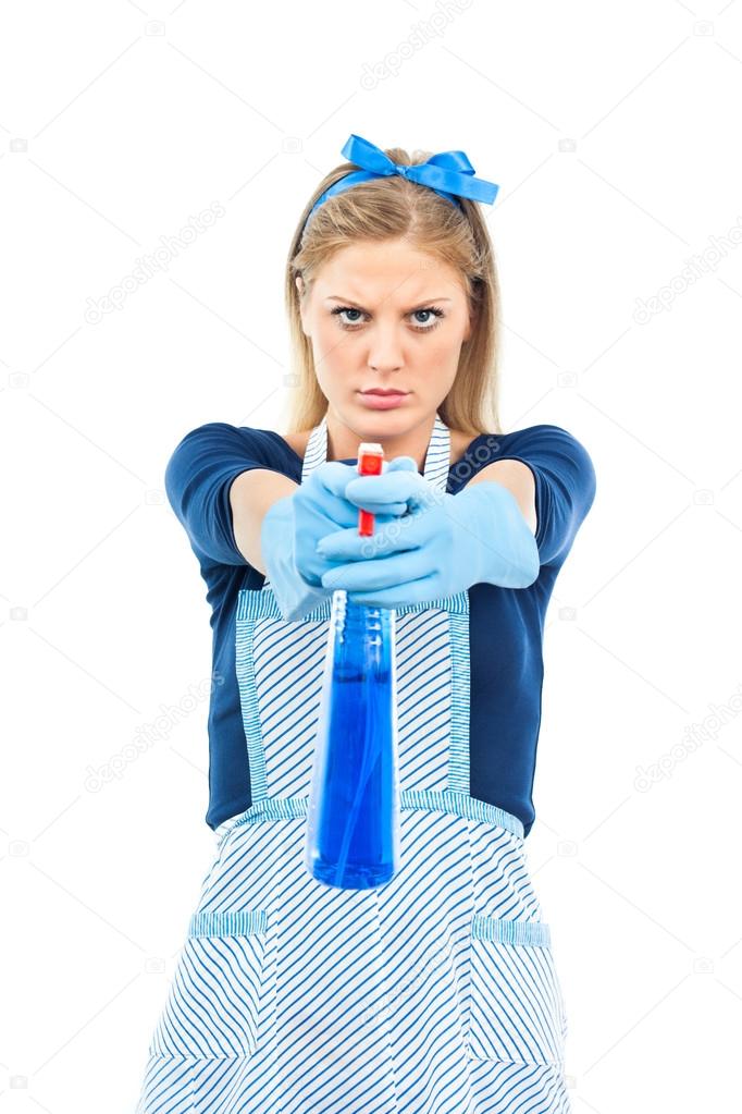 young housewife aiming with spray
