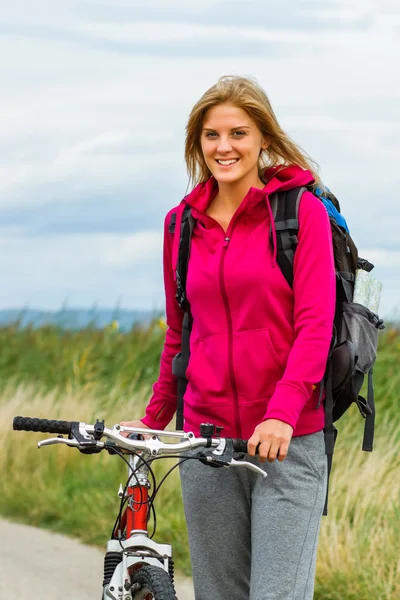 Young woman with bicycle — Stock Photo, Image