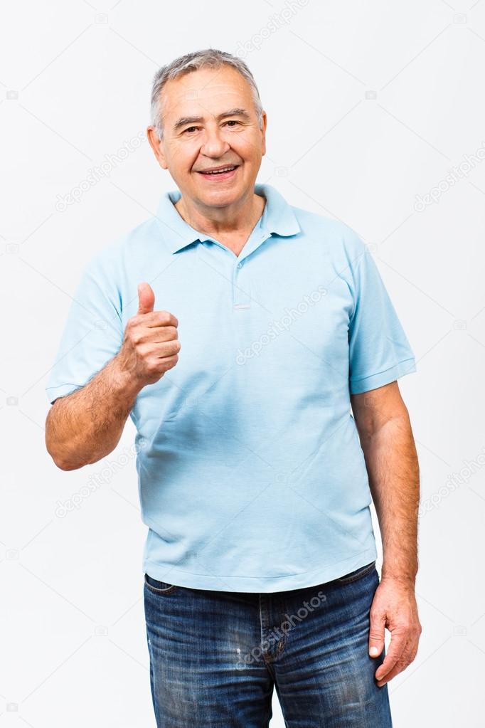 happy senior man showing thumb up