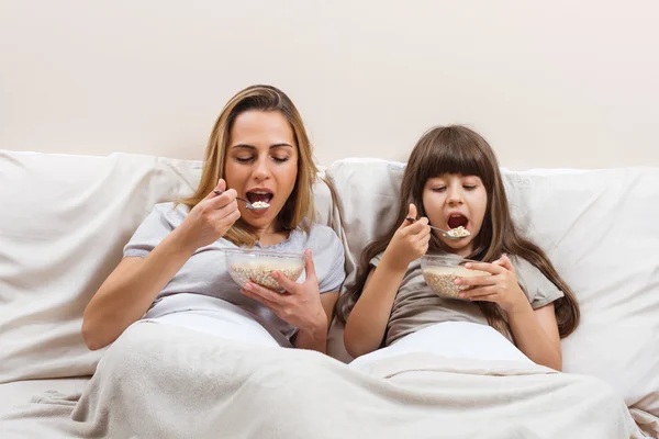 Matka i córka jedzą śniadanie — Zdjęcie stockowe