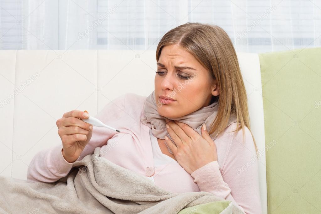 sick woman with thermometer
