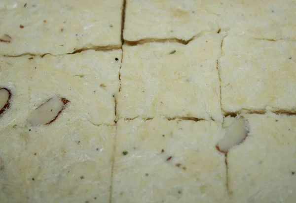 soanpapdi, Indian sweets. Soan papdi is a popular Indian dessert. It is usually cube-shaped or served as flakes, and has a crisp and flaky texture. It was traditionally sold loose in a rolled paper cone, but modern industrial production has led.