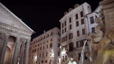 ROME, ITALY - SEPTEMBRE 2, 2020: Ancient Roman Pantheon Temple at night surrounded by tourist and visitors, people enloying powerful church with rich history and high marble columns, admiring and