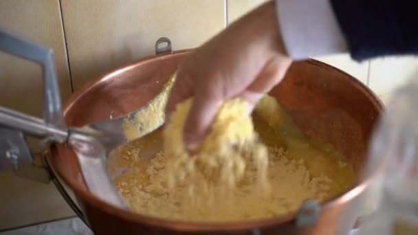 Corn porriage prepared at home, italian winter meal. Pouring and stirring maize flour in cooper pan on low fire, healthy eating and nutrition — Stockvideo