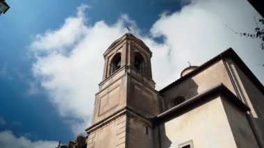 Gökyüzünün arka planında antik ortaçağ tarihi binası bulutlu, Tuscania köyünde çan kulesi olan karakteristik kilise, Viterbo vilayeti. Antik İtalyan çağının anıtsal binası