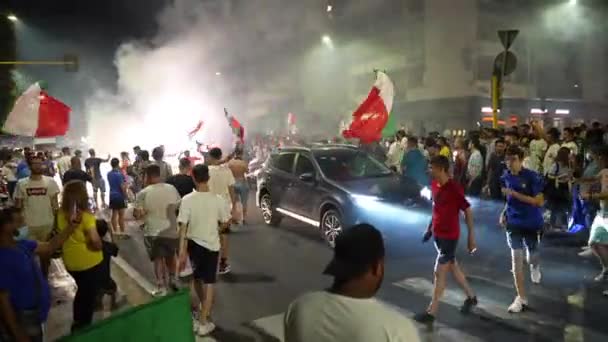 ROMA, ITÁLIA - JULHO 11, 2021: torcedores italianos com bandeiras ondulando bloqueando estradas após a vitória do time de futebol na UEFA EURO 2020, torcedores de rua felizes dançando na estrada, pulando, gritando de alegria e — Vídeo de Stock