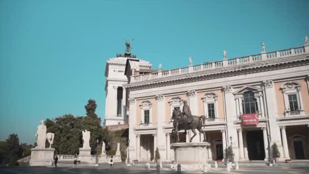 ローマ,イタリア- 2020年10月30日:乗馬記念碑がある広場を歩いている人もいます。古い時代の壮大な歴史的建造物,コロネードと彫刻オン. — ストック動画