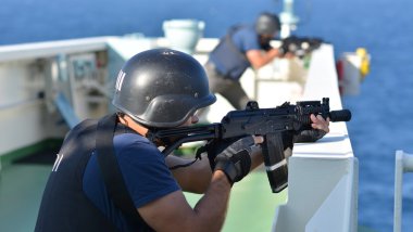 OPEN SEA / ON BOARD A SHIP / INDIAN OCEAN - JANUARY 28, 2015. Exercise of Armed Piracy Security Team on board of ship. clipart