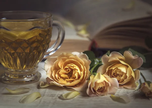 Still life with delicate roses and books.