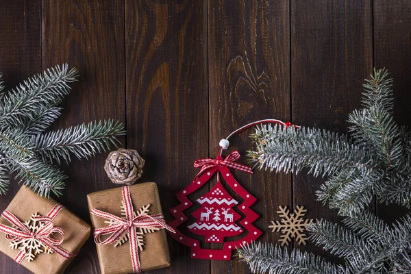 素朴な木製のテーブルの背景にギフト モミの枝や季節の装飾が施されたクリスマスカード テキストのコピースペースを持つトップビュー — ストック写真