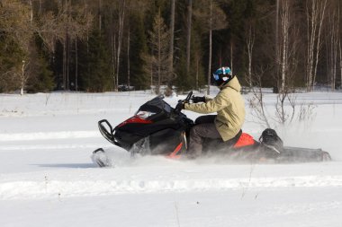 Athletes on a snowmobile. clipart