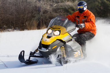 Athletes on a snowmobile. clipart