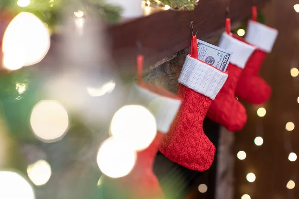 American Dollars Christmas Red Socks Gifts Fireplace Bokeh Lights — Stock Photo, Image