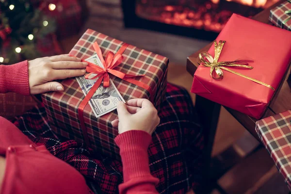 Žena Sedí Vánočního Stromku Krbu Dává Americké Dolary Pod Červenou — Stock fotografie
