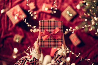 Parlayan çelengin içinden elini uzatan kadın. Noel zamanı. Üst görünüm. 