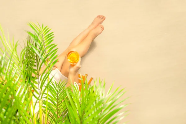 Allein Sitzt Eine Frau Unter Palmenzweigen Mit Einem Glas Wasser — Stockfoto