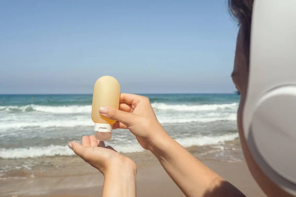 Woman Headphones Listen Music Applying Sunscreen Skin Beach Looking Sea — Stock Photo, Image