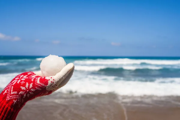 Женщина Рождественских Перчатках Держит Снежок Пляже Напротив Морской Волны Новый — стоковое фото