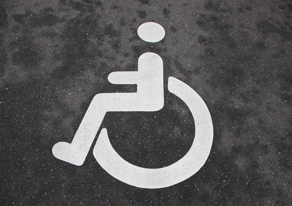 White Handicap Disabled Sign on Black Asphalt — Stock Photo, Image