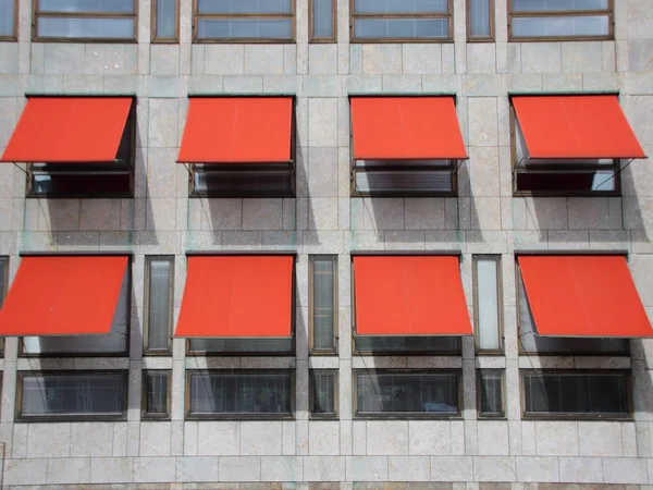 Tenda parasole rosso sulla facciata moderna dell'edificio — Foto Stock