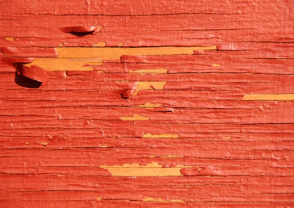 Worn yellow wood with red exfoliated paint — Stock Photo, Image