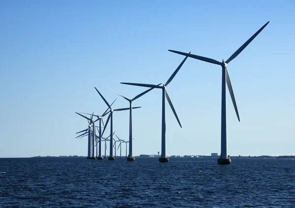 Perspective line of ocean windmills in back light — Stock Photo, Image