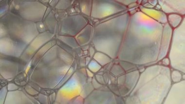 Bubbles behind the glass. a red liquid flows from above.